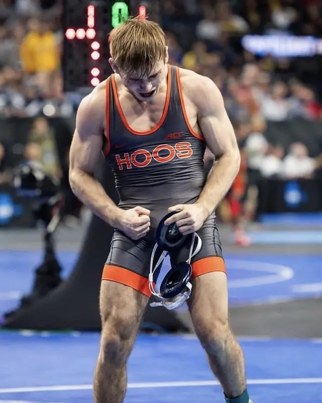 Jack Gioffre, in a Virginia singlet, walks off the mat at a college tournament.