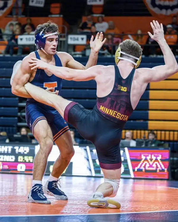 Michael Gioffre, in an Illinois singlet, holds an opponent’s leg during a college match.
