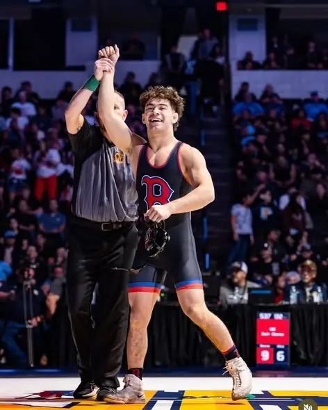 A referee raises the hand of a Dethrone Wrestling Club wrestler at the 2026 California high school state tournament in Bakersfield.