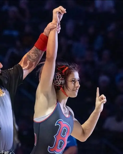 A referee raises the hand of a Dethrone Wrestling Club wrestler at the 2026 California high school state tournament in Bakersfield.