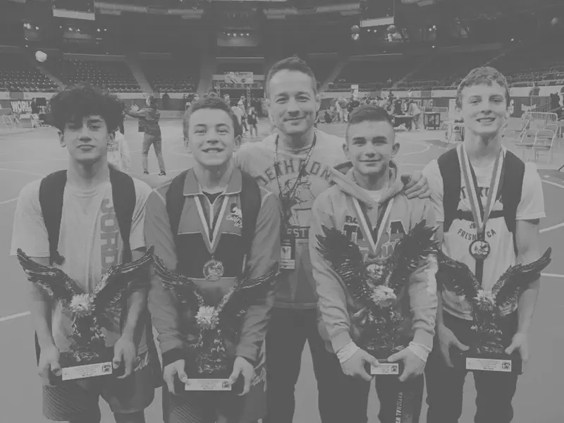 Young Dethrone wrestlers line up with their tournament medals.
